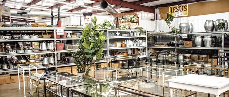 A to Z Gifts Alma Arkansas store interior overview showing warehouse-style layout with shelving aisles and glass display tables in the large retail space
