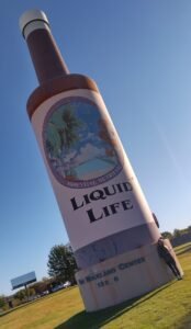 Vintage-style World's Largest Hair Tonic Bottle, a landmark tied to Liquid Life's history.