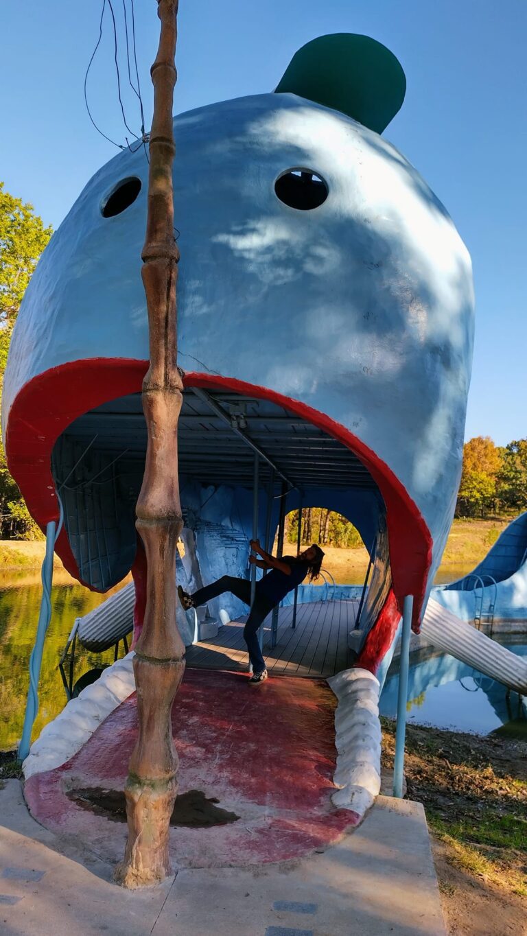 Zach pretending to be dragged inside the Blue Whale of Catoosa, a giant concrete whale on Route 66, Oklahoma