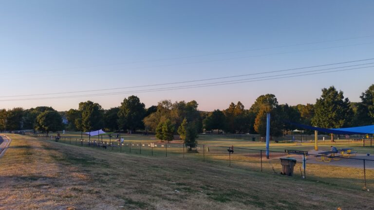 Large fenced dog park with multiple play areas and agility course at Benjamin's Biscuit Acres Dog Park Tulsa.