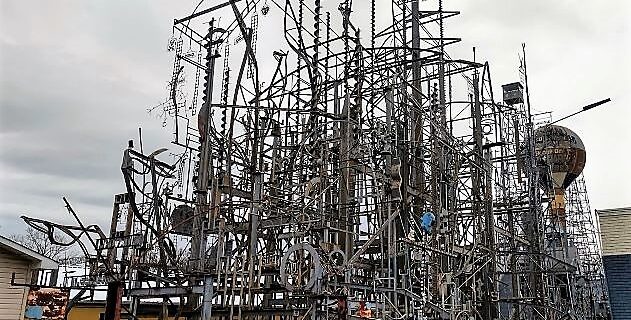 Towering welded steel structure at Billy Tripp’s Mindfield Brownsville TN, with interconnected beams, rods, and wires forming an intricate, layered outdoor art installation.