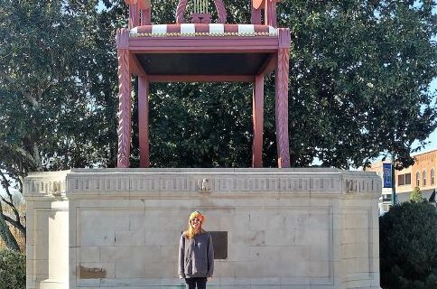 The World's Largest Duncan Phyfe Chair in Thomasville, NC—a towering replica standing atop a stone pedestal with engraved details, surrounded by trees and buildings
