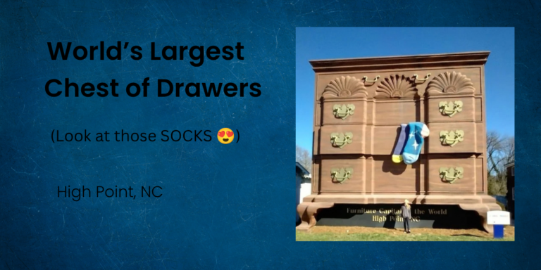 Giant chest of drawers roadside attraction in High Point, North Carolina, with oversized blue socks hanging from one drawer.