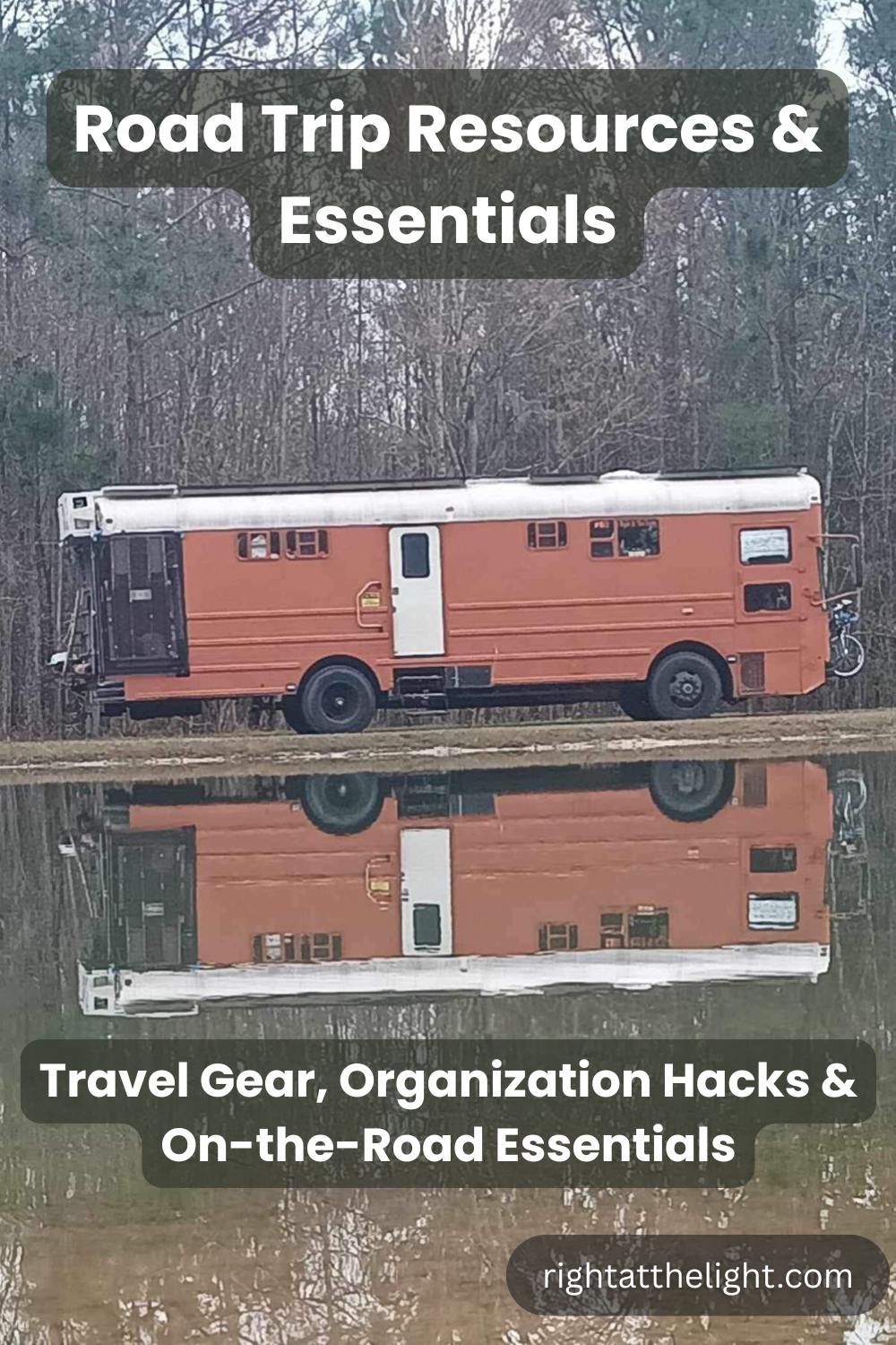 A large orange skoolie tiny-home bus reflected in calm water with winter trees in the background, representing road trip resources for travelers looking for practical gear and organization ideas.