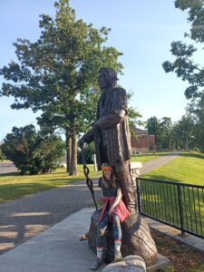 Chief Bemidji Statue with woman seated in front