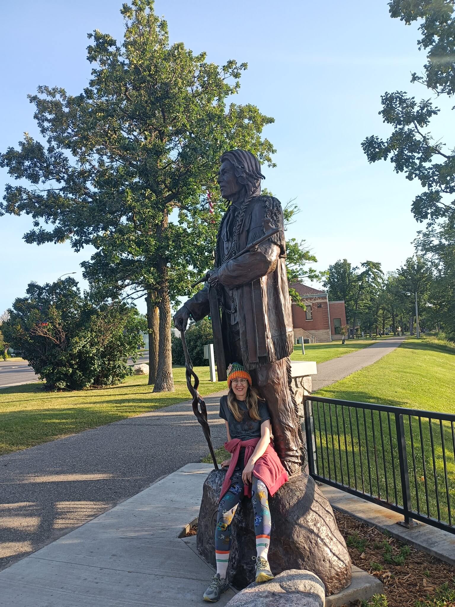 Chief Bemidji Statue with woman seated in front.