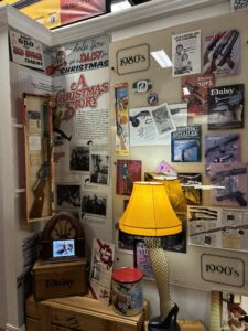A Christmas Story display wall featuring leg lamp and Red Ryder memorabilia at Daisy Airgun Museum