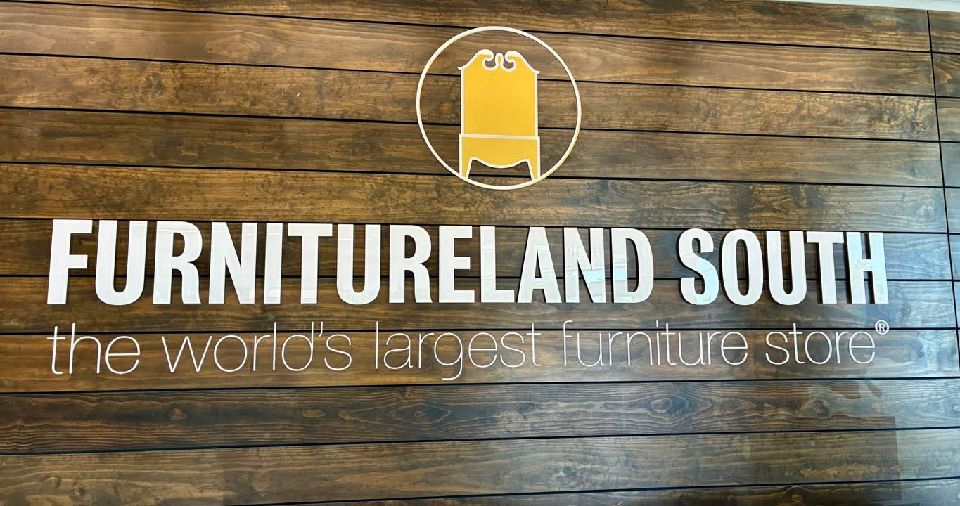 Furnitureland South sign reading “the world’s largest furniture store”