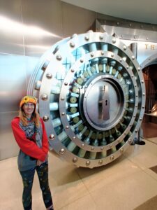 Standing beside the replica Coca-Cola Secret Formula Vault inside the World of Coca-Cola museum in Atlanta, Georgia.