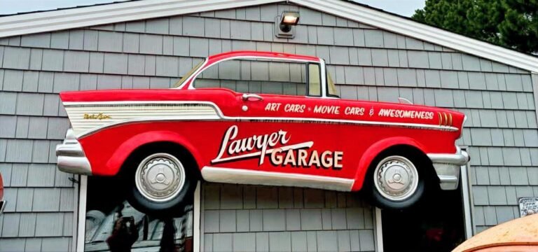 Red vintage Lawyer Garage pickup truck sign mounted above the entrance to the Lawyer Garage collection in Virginia Beach, Virginia.