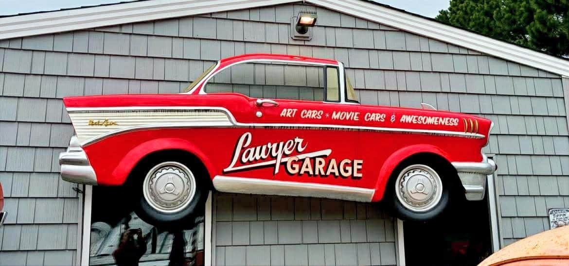 Red vintage Lawyer Garage pickup truck sign mounted above the entrance to the Lawyer Garage collection in Virginia Beach, Virginia.