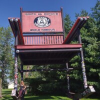 World's Second Largest Rocking Chair at Fanning 66 Outpost in Cuba Missouri with pink striped awning