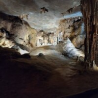 Stalactites and stalagmites inside Fantastic Caverns in Springfield, Missouri, illuminated to highlight dramatic cave textures and mineral formations.