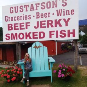 Oversized wooden chair outside Gustafson’s Smoked Fish in Moran, Michigan, part of a playful roadside photo tradition.