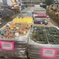 A to Z Gifts Alma Arkansas candle section displaying large selection of jar candles and pillar candles organized in bins with sale signs