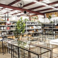 A to Z Gifts Alma Arkansas store interior overview showing warehouse-style layout with shelving aisles and glass display tables in the large retail space