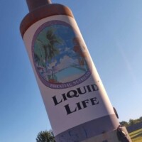 lose-up of Tulsa’s 25-foot Hair Tonic Bottle, showcasing its detailed label and structure.