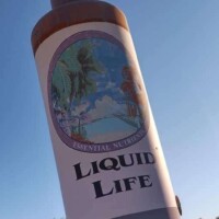 The giant Hair Tonic Bottle in front of Liquid Life headquarters, visible from the road in Tulsa, OK.