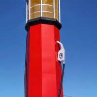 World's Tallest Gas Pump Sapulpa Oklahoma towering 66 feet high with red base, yellow middle section, and circular sign on top against blue sky