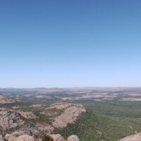 Panoramic mountain and valley vista from Mount Scott summit with clear blue skies"
