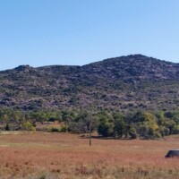 Panoramic view of Wichita Mountains landscape with rolling hills and scattered trees