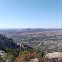 Sweeping valley view from Mount Scott summit showing winding roads and distant plains
