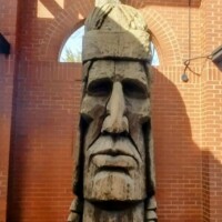 Peter Wolf Toth's 'Love is Life' sculpture from his Trail of Whispering Giants series - a massive carved wooden tribute to Native American heritage, photographed in its permanent display space in Little Rock, Arkansas