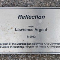 Informational plaque for the Reflection sculpture in Nashville’s Shelby Park—credits artist Lawrence Argent (2012) and notes funding by the Metropolitan Nashville Arts Commission.