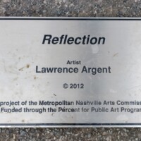 Informational plaque for the Reflection sculpture in Nashville’s Shelby Park—credits artist Lawrence Argent (2012) and notes funding by the Metropolitan Nashville Arts Commission.