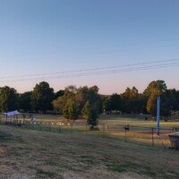 Large fenced dog park with multiple play areas and agility course at Benjamin's Biscuit Acres Dog Park Tulsa.