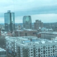 Downtown Knoxville aerial view – High-rise towers, residential buildings, and skyline under a cloudy sky.