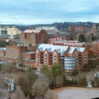 Wide cityscape: A sweeping aerial view of Knoxville, TN, from the Sunsphere observation deck—capturing downtown, residential areas, and distant hills.