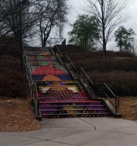 Outdoor staircase painted with colorful geometric patterns