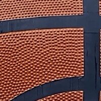 Close-up view of the World's Largest Basketball in Knoxville, Tennessee, showcasing its textured surface and black ribbing