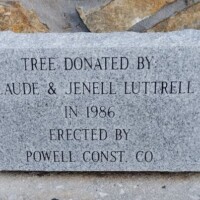 Stone plaque acknowledging the tree donation by Claude & Jenell Luttrell in 1986 and construction by Powell Construction Company for the Junaluska Whispering Giant sculpture site in Johnson City, Tennessee