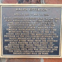 A commemorative plaque honoring Ralph Epperson, founder of WPAQ 740 AM, the first radio station in Surry County. The plaque highlights the station’s role in preserving local old-time music from North Carolina and Virginia, mentions the Merry-Go-Round as one of the longest-running live radio broadcasts, and acknowledges Epperson's induction into the North Carolina Association of Broadcasters Hall of Fame.