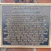 A commemorative plaque honoring Ralph Epperson, founder of WPAQ 740 AM, the first radio station in Surry County. The plaque highlights the station’s role in preserving local old-time music from North Carolina and Virginia, mentions the Merry-Go-Round as one of the longest-running live radio broadcasts, and acknowledges Epperson's induction into the North Carolina Association of Broadcasters Hall of Fame.