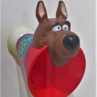 Scooby-Doo-themed kazoo toy with a red cone-shaped base, a blue center featuring the ‘Scooby-Doo’ logo, and a molded Scooby head on top—ready to solve mysteries and toot out trouble