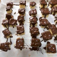A tray of chocolate-covered treats on parchment paper