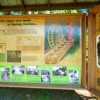 Informational panel display about Civil War-era sugar production at Spring Garden, featuring illustrations and text on sugar-making methods and notable historical figures.