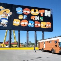 Colorful billboard at South of the Border Roadside attraction, featuring Pedro in a sombrero and poncho beside an RV, set under a clear Carolina sky.