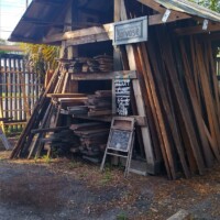 Outdoor reclaimed wood shed at The Repurpose Project in Gainesville, Florida, stocked with heart pine boards and other salvaged lumber for sale.