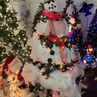 Christmas tree decorated as a snowman with cotton snow, colorful lights, and a top hat at Christmas Winter Wonderland in Fort Smith, Arkansas.