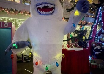 Large white yeti Christmas display holding a glowing star and decorated with colorful lights inside Christmas Winter Wonderland in Fort Smith, Arkansas.