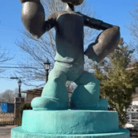 Bronze Popeye statue standing in a fountain at Popeye's Garden in Alma, Arkansas