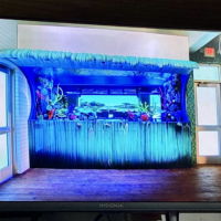 Screenshot from Tanked Season 7 Episode 6 showing the completed wave aquarium installed at Salt Life Food Shack with coral and tropical fish visible inside in St. Augustine Beach Florida