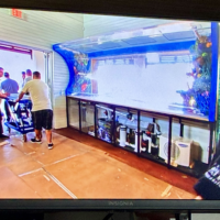 Screenshot from Tanked Season 7 Episode 6 showing the ATM crew installing the custom wave aquarium into Salt Life Food Shack in St. Augustine Beach Florida