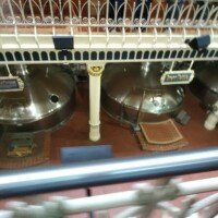Close-up view of the copper Brew Kettle at Anheuser-Busch, labeled with a brass sign.