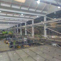Overhead view of the Anheuser-Busch bottling line, Bottle Line 34, with pipes and packaging machinery.