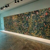 Large textured floral wall installation on display inside Crystal Bridges Museum of American Art.